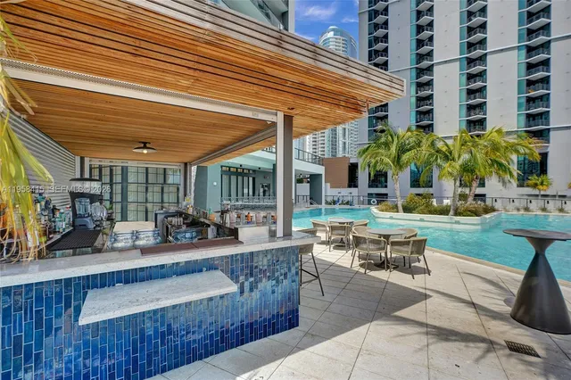 a building outdoor space with patio furniture and potted plants