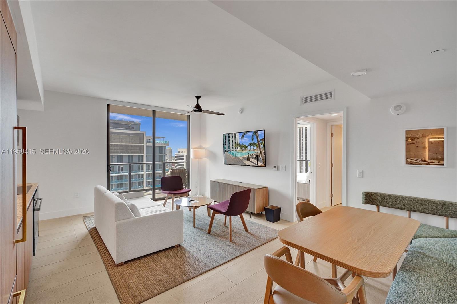 159 Northeast 6th Street, Unit 3405 Miami, FL 33132 - Photo 5 of 37 a living room with furniture and a large window