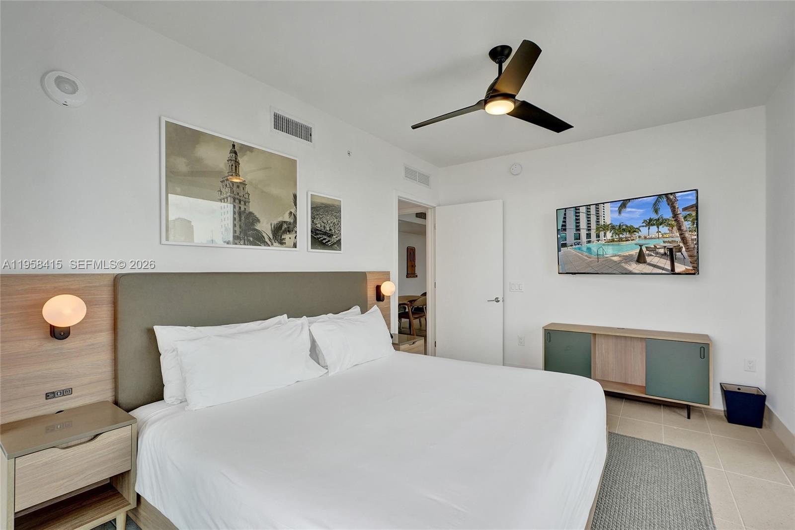 159 Northeast 6th Street, Unit 3405 Miami, FL 33132 - Photo 8 of 37 a bedroom with a large bed and a chandelier