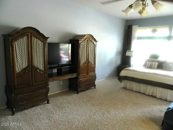 a bedroom with a bed and a mirror