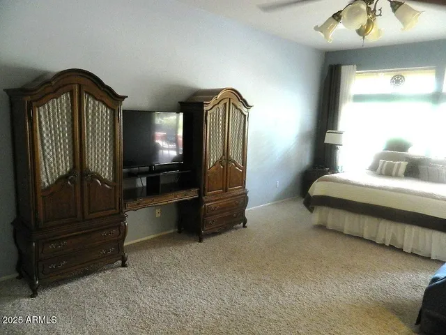 a bedroom with a bed and a mirror