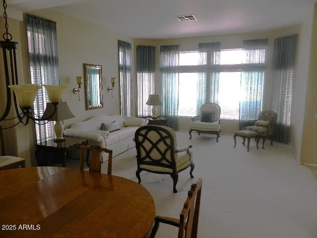 a living room with fireplace furniture and a large window