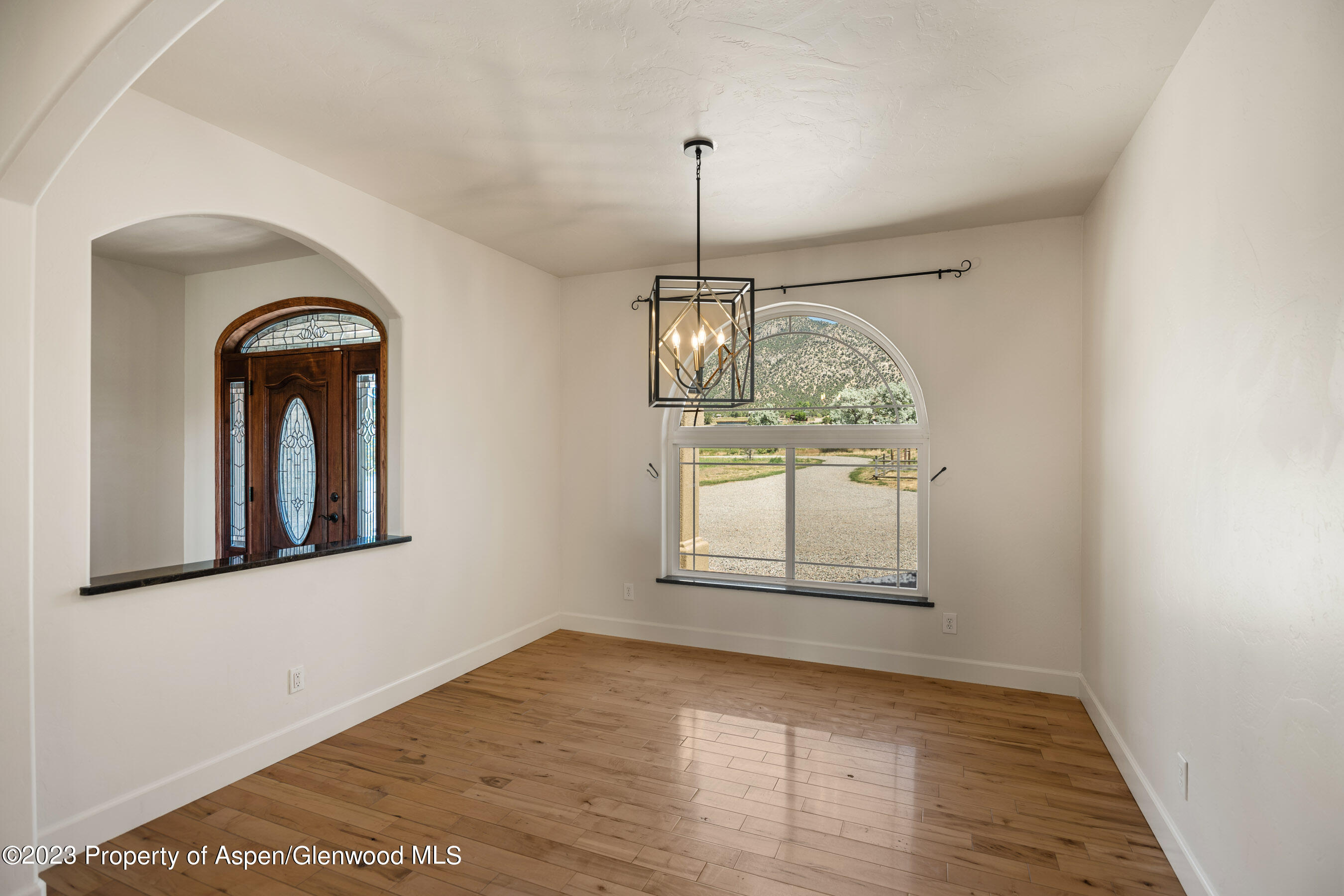 1148 County Road 237 Silt, CO 81652 - Photo 13 of 80 an empty room with wooden floor windows and cabinet