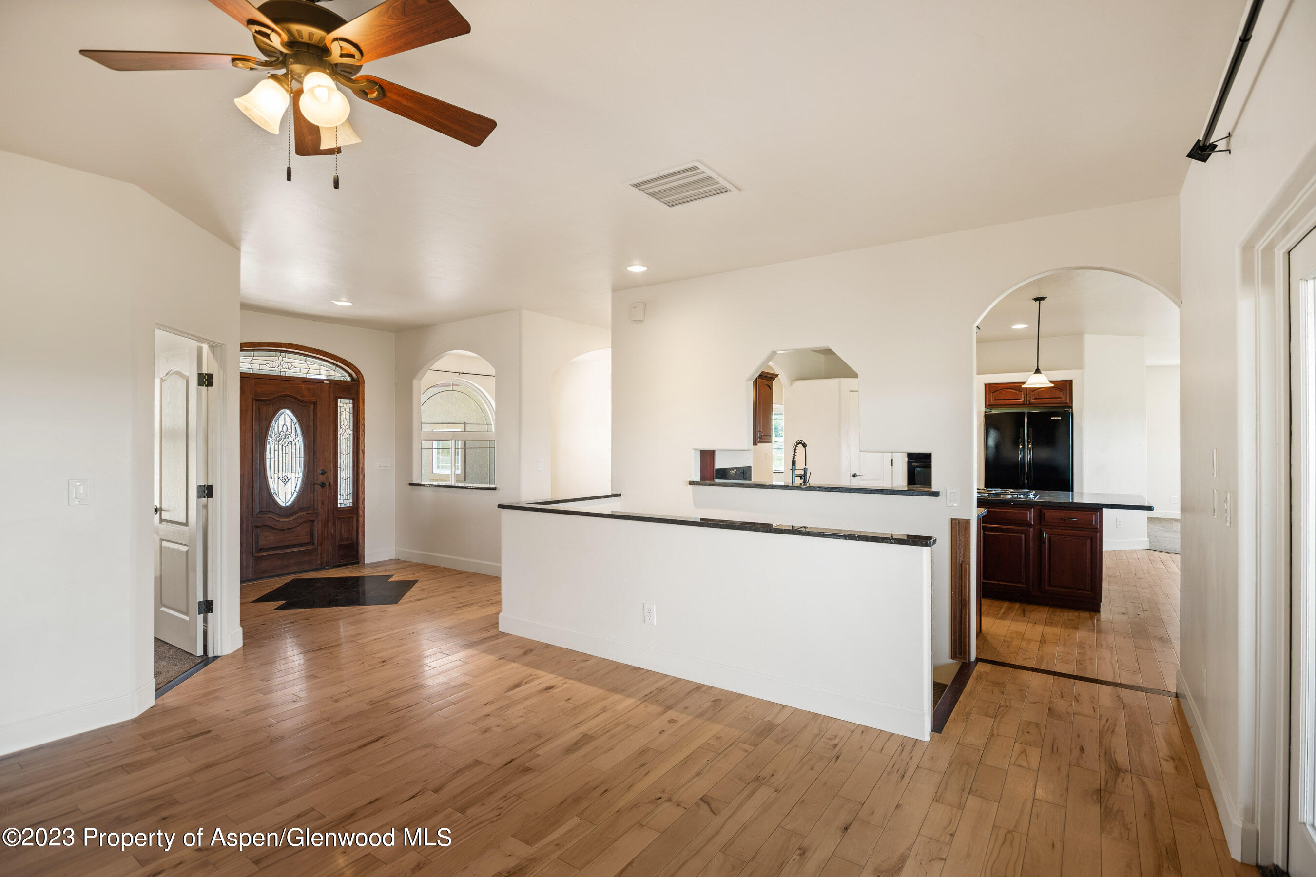 1148 County Road 237 Silt, CO 81652 - Photo 14 of 80 a kitchen with stainless steel appliances granite countertop a refrigerator a sink a stove and island with wooden floor