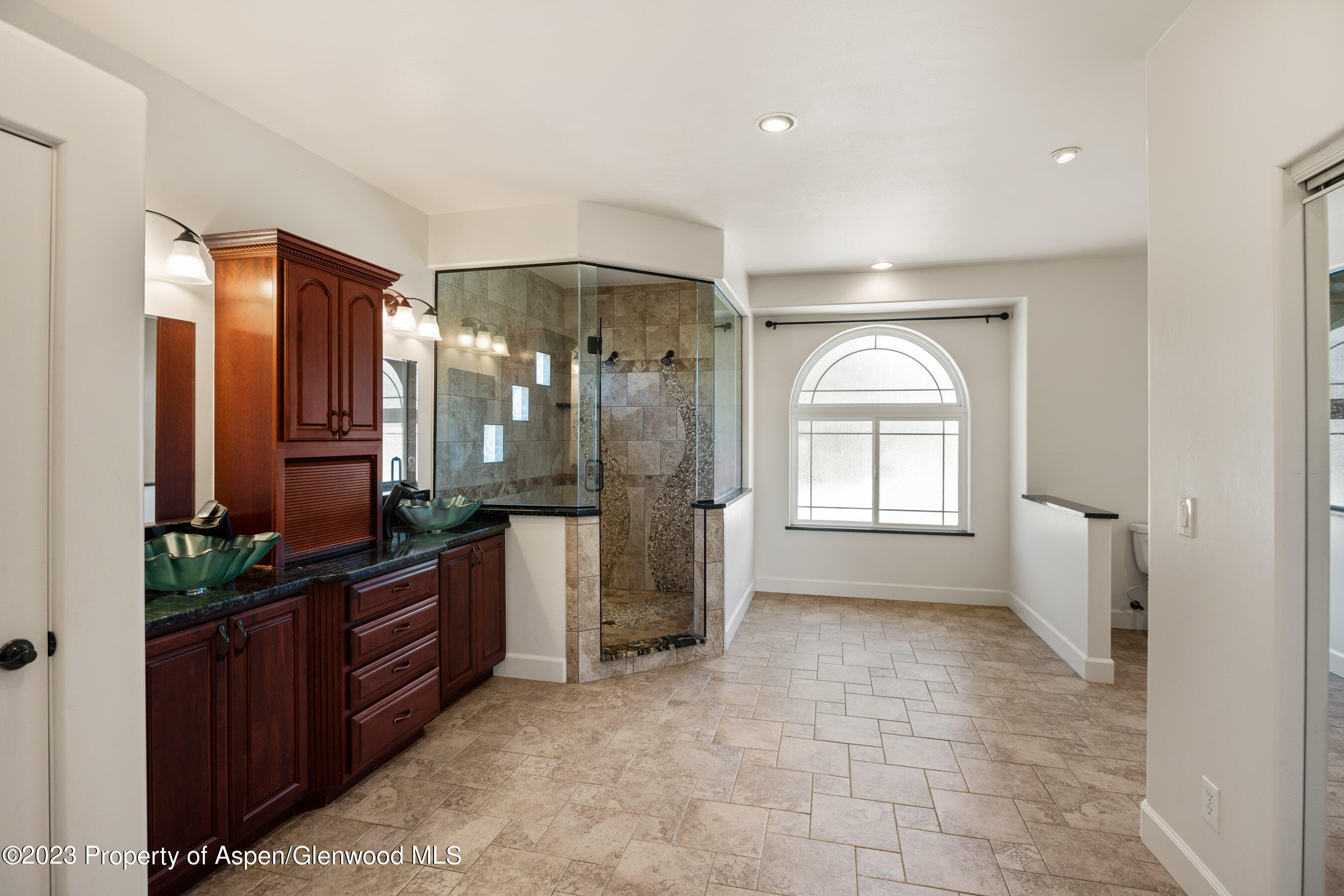 1148 County Road 237 Silt, CO 81652 - Photo 17 of 80 a spacious bathroom with a granite countertop sink a mirror and a bathtub