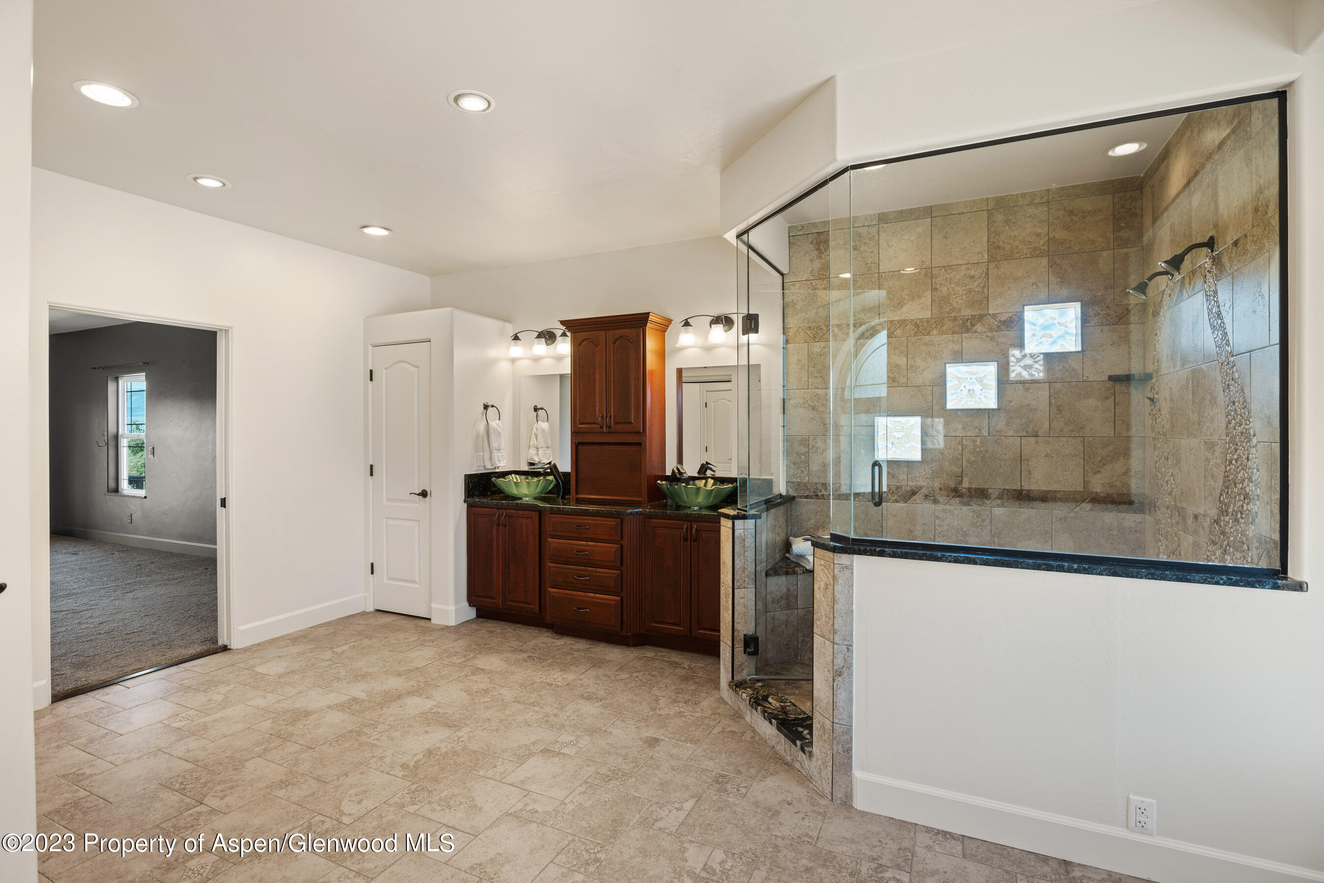 1148 County Road 237 Silt, CO 81652 - Photo 18 of 80 a large bathroom with a granite countertop sink a mirror and a bathtub