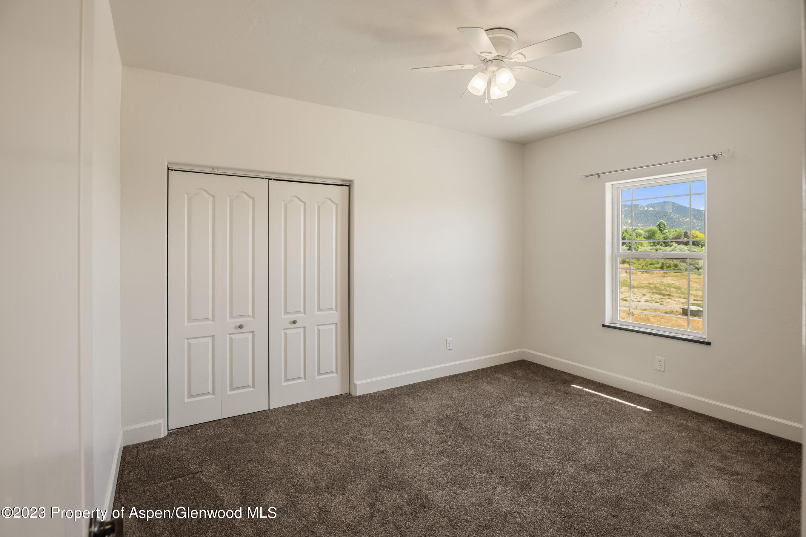 1148 County Road 237 Silt, CO 81652 - Photo 20 of 80 an empty room with windows and fan