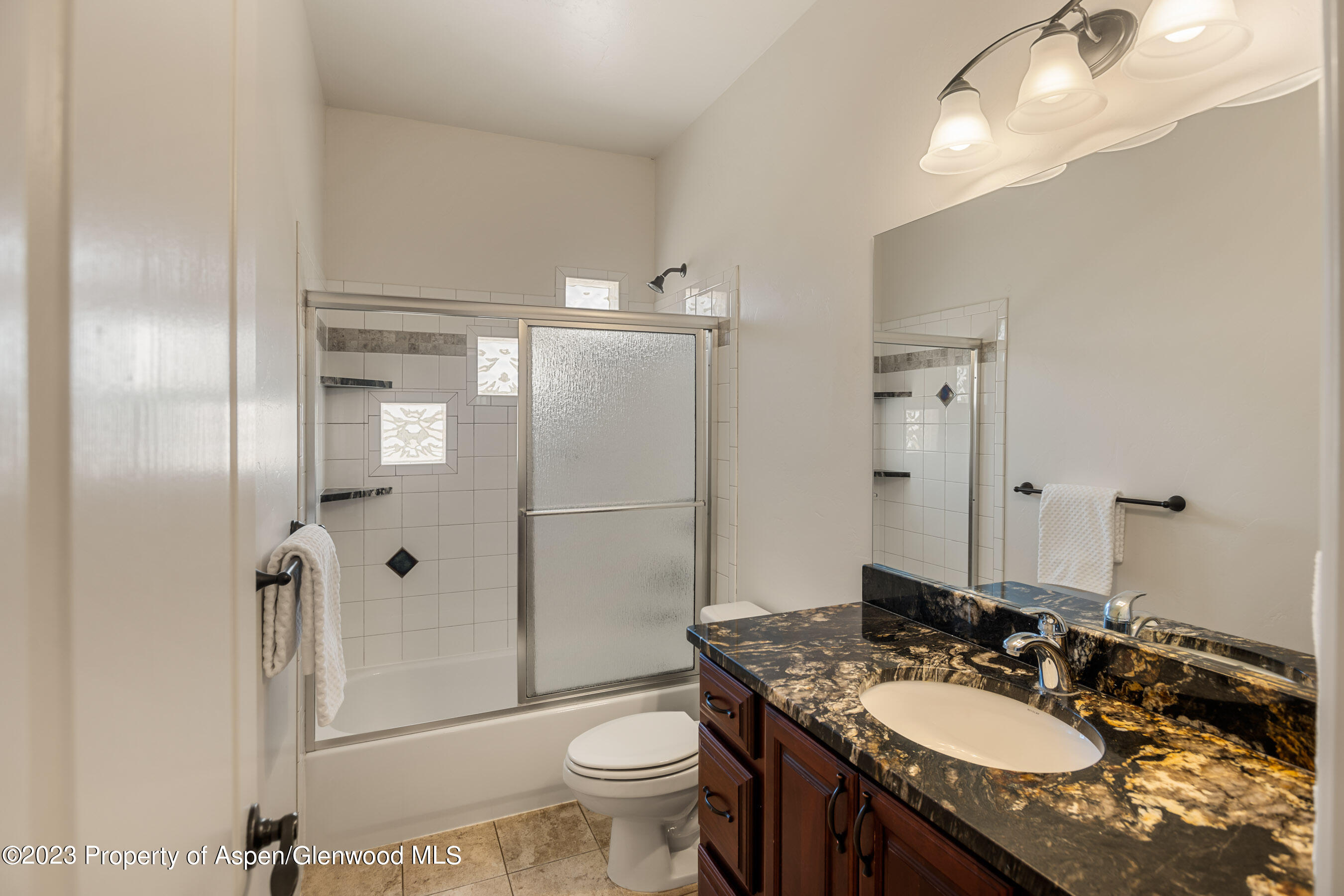 1148 County Road 237 Silt, CO 81652 - Photo 21 of 80 a bathroom with a granite countertop sink toilet and shower