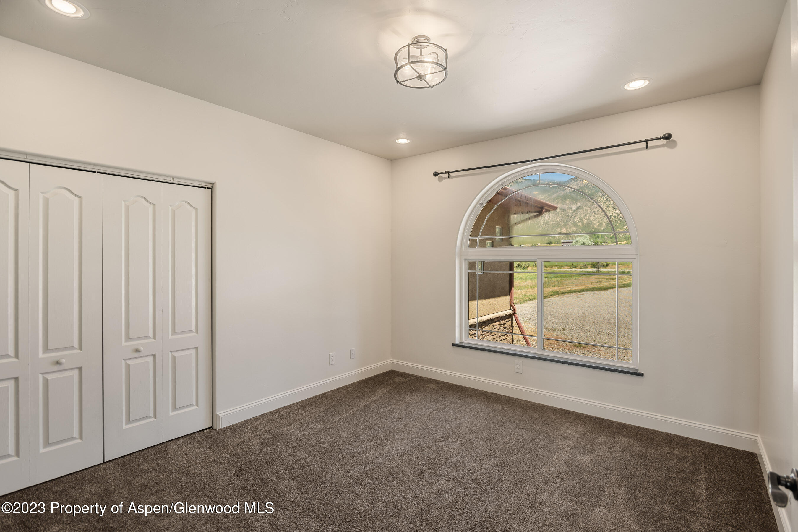 1148 County Road 237 Silt, CO 81652 - Photo 23 of 80 an empty room with wooden floor cabinet and window