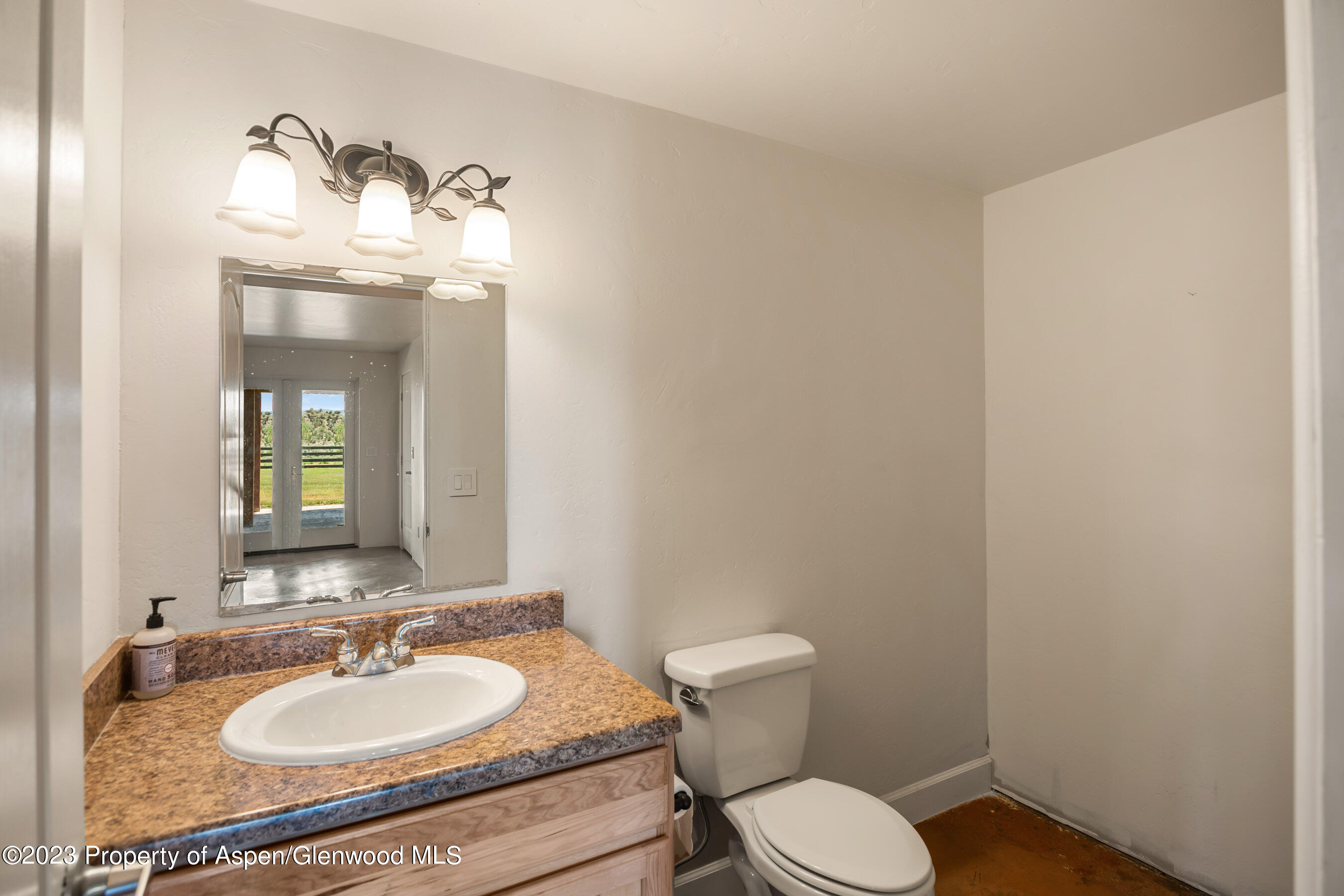 1148 County Road 237 Silt, CO 81652 - Photo 25 of 80 a bathroom with a granite countertop sink and a mirror