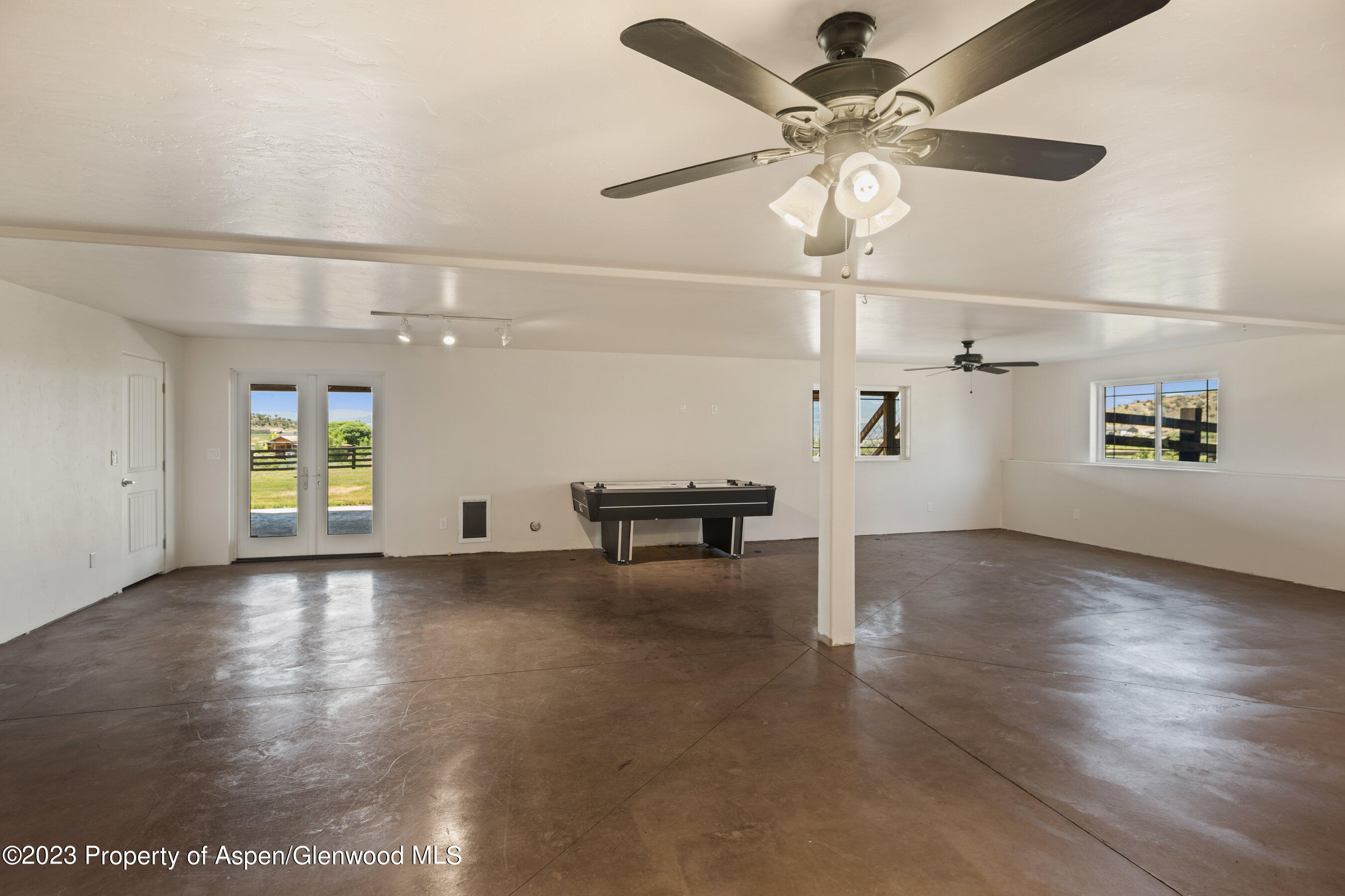 1148 County Road 237 Silt, CO 81652 - Photo 27 of 80 an empty room with windows and ceiling fan