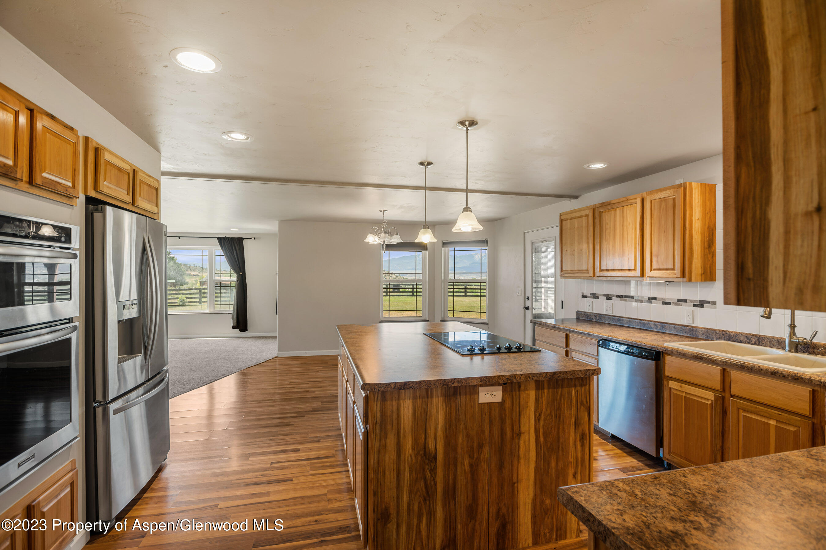 1148 County Road 237 Silt, CO 81652 - Photo 32 of 80 a kitchen with stainless steel appliances granite countertop a sink and wooden cabinets