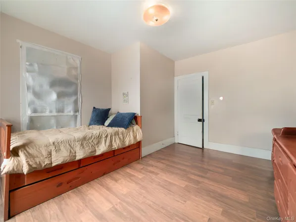 a bedroom with a bed and a painting on the wall
