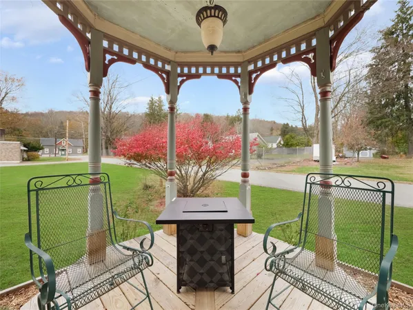 a view of a porch with a table and chairs