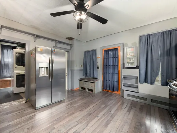 a view of a hallway with wooden floor and closet