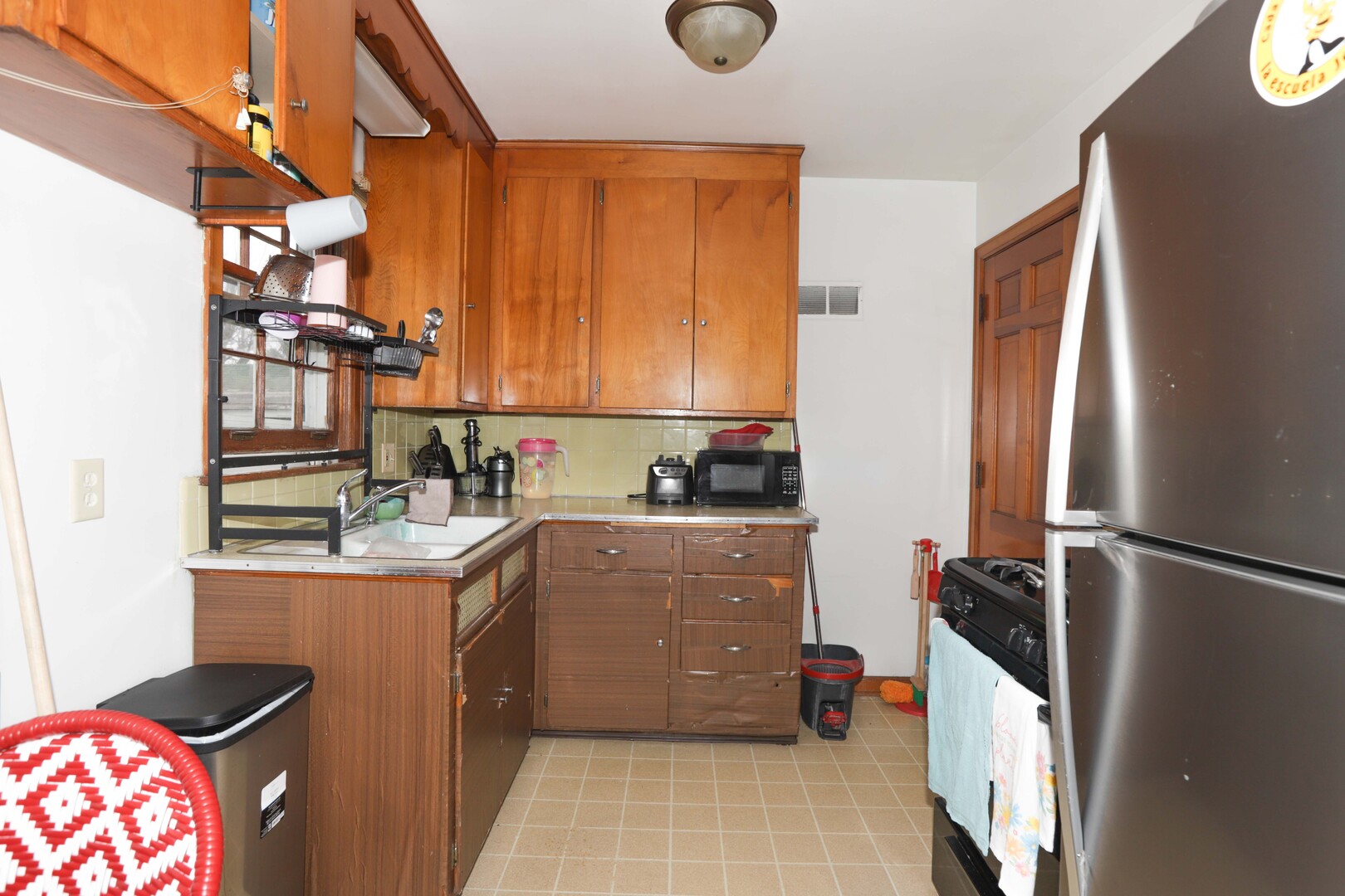 900 Garfield Road Harvard, IL 60033 - Photo 3 of 17 a kitchen with stainless steel appliances granite countertop a refrigerator and a stove