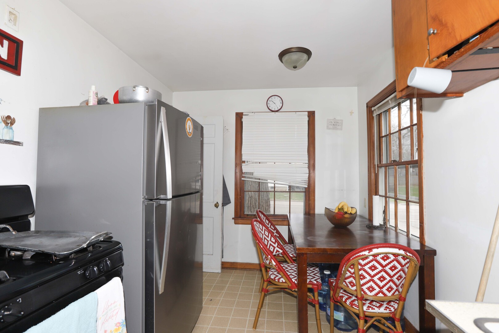 900 Garfield Road Harvard, IL 60033 - Photo 4 of 17 a kitchen with stainless steel appliances granite countertop a dining table chairs and a refrigerator