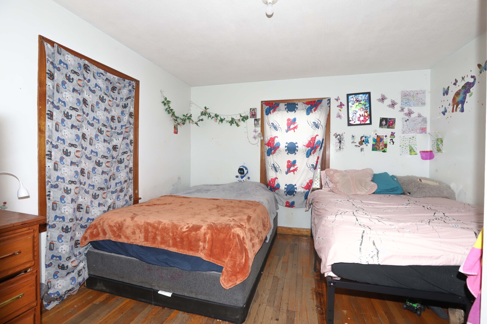 900 Garfield Road Harvard, IL 60033 - Photo 7 of 17 a bedroom with a bed and dresser with wall paintings