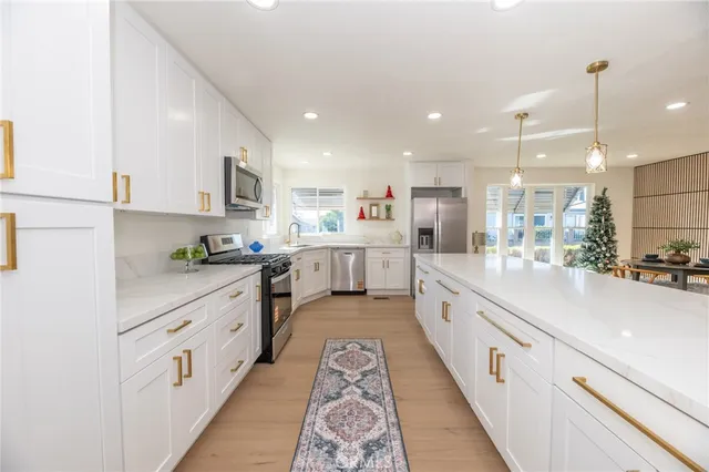 a kitchen with white cabinets and white appliances