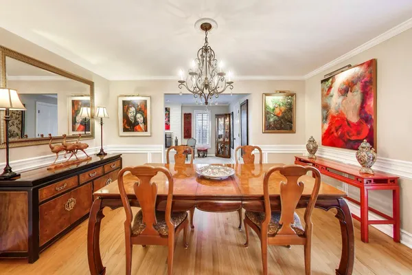 a view of a dining room with furniture and chandelier
