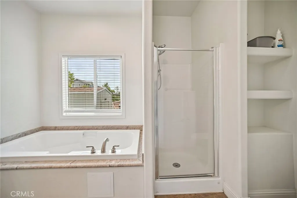 250 East Telegraph Road, Unit 307 Fillmore, CA 93015 - Photo 27 of 36 a bathroom with a granite countertop tub sink and mirror