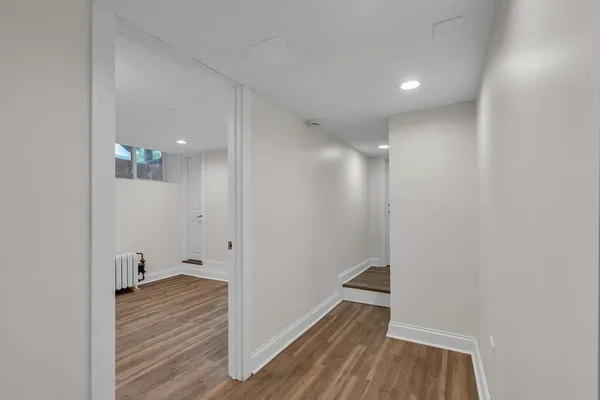 a view of a hallway with wooden floor