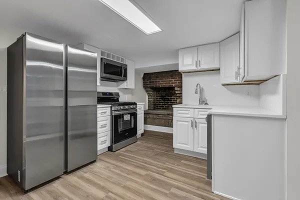 a kitchen with a refrigerator stove and microwave