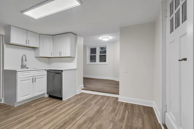 a view of kitchen with wooden floor and electronic appliances