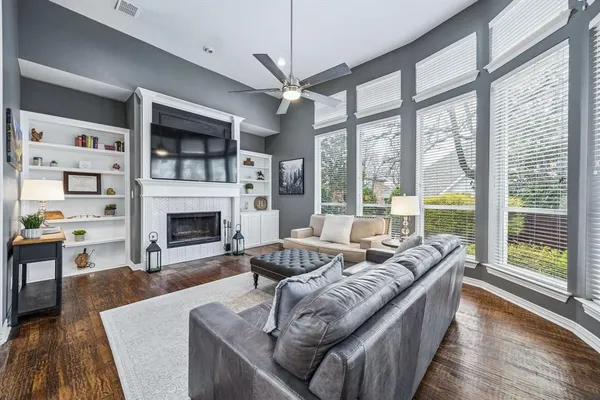 a living room with furniture large window and a fireplace