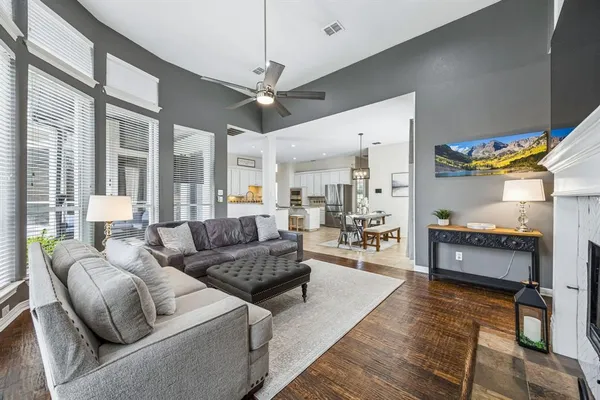 a living room with furniture and a chandelier