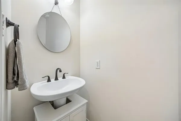 a bathroom with a sink a mirror and a toilet
