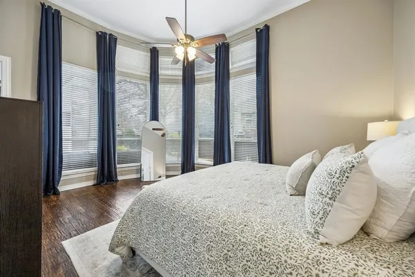 a bedroom with a large bed and a chandelier