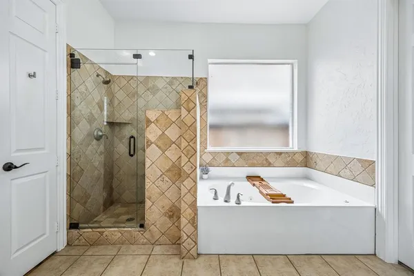 a bathroom with a bathtub and shower