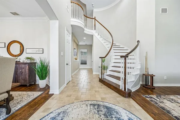 a view of a hallway with wooden floor and entryway