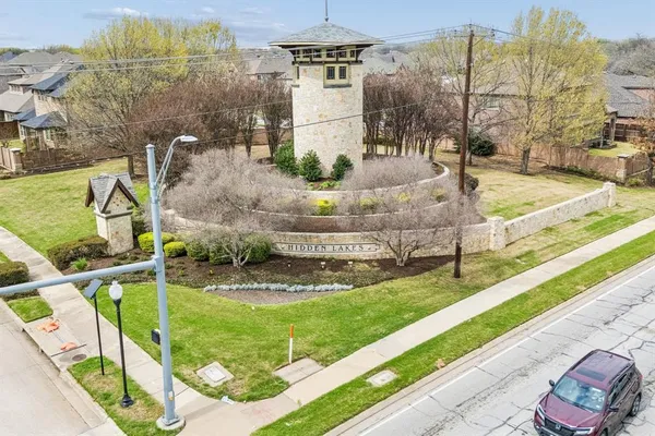 an aerial view of a house with a garden and lake view