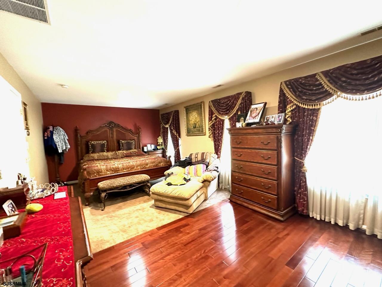 9 Ruth Court Absecon, NJ 08201 - Photo 9 of 38 a bedroom with furniture and a wooden floor