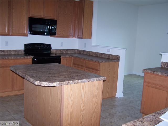 2516 Covington Loop Graham, NC 27253 - Photo 5 of 16 Kitchen. Kitchen has Island and Large Pantry! Black Appliances!