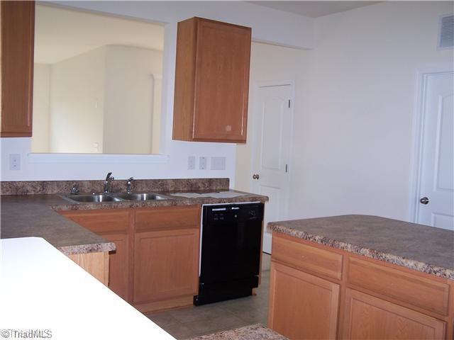 2516 Covington Loop Graham, NC 27253 - Photo 6 of 16 Kitchen. Another View of Kitchen. Lots of counter space and cabinets! Island and Black Applainces! Large Pantry!