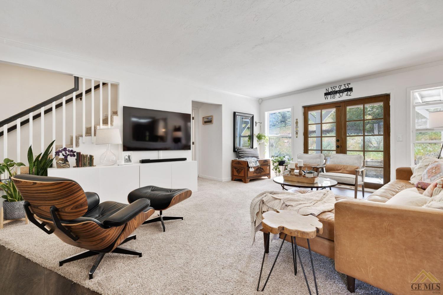 Undisclosed Address Tehachapi, CA 93561 - Photo 12 of 57 a living room with furniture a flat screen tv and floor to ceiling window