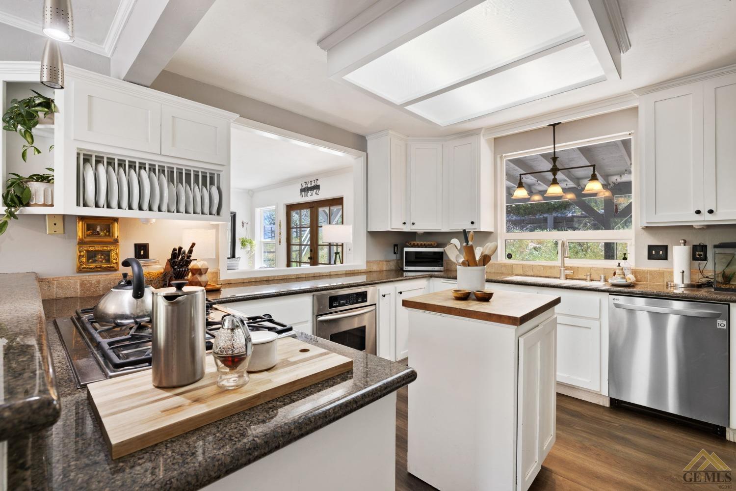 Undisclosed Address Tehachapi, CA 93561 - Photo 21 of 57 a kitchen with a stove a sink dishwasher and a refrigerator