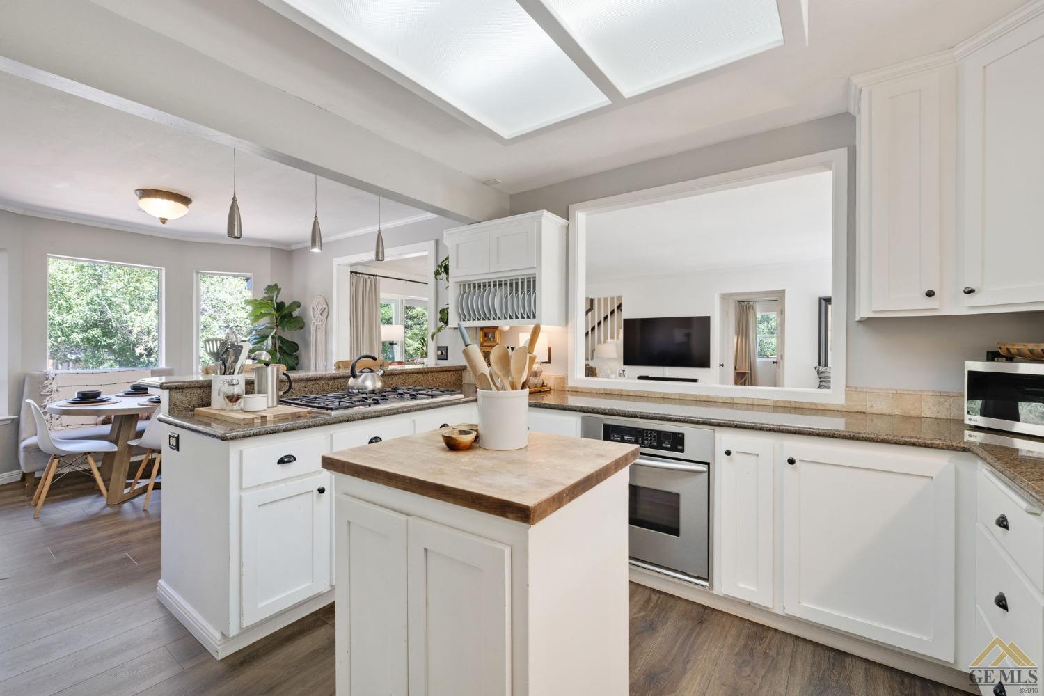 Undisclosed Address Tehachapi, CA 93561 - Photo 22 of 57 a kitchen with white cabinets and white appliances