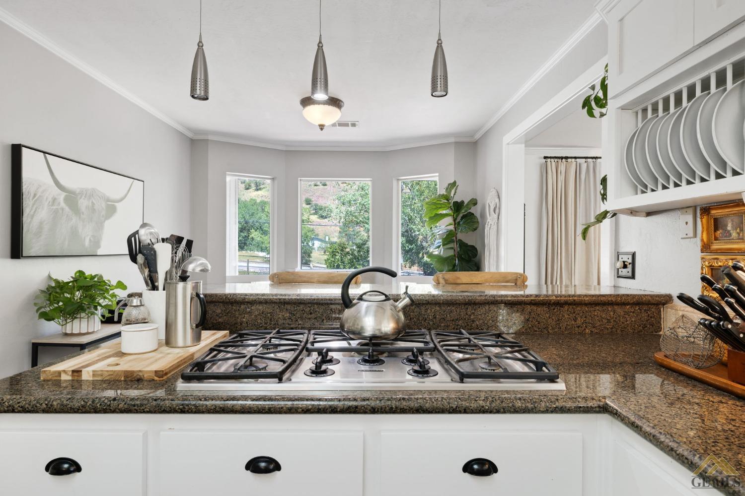 Undisclosed Address Tehachapi, CA 93561 - Photo 23 of 57 a kitchen with kitchen island granite countertop a sink a counter top space and a window
