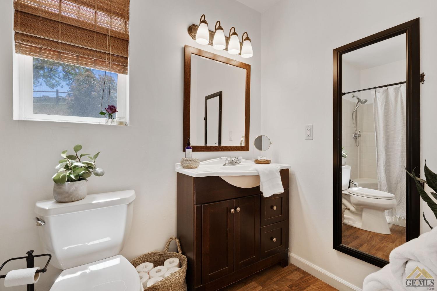 Undisclosed Address Tehachapi, CA 93561 - Photo 29 of 57 a bathroom with a toilet a sink and a mirror