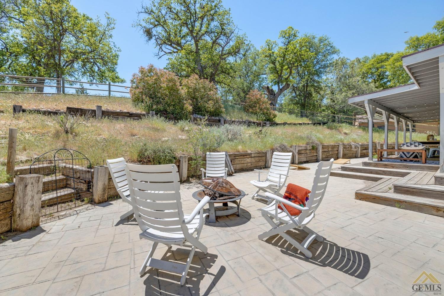 Undisclosed Address Tehachapi, CA 93561 - Photo 38 of 57 a view of a lake with couches chairs and table