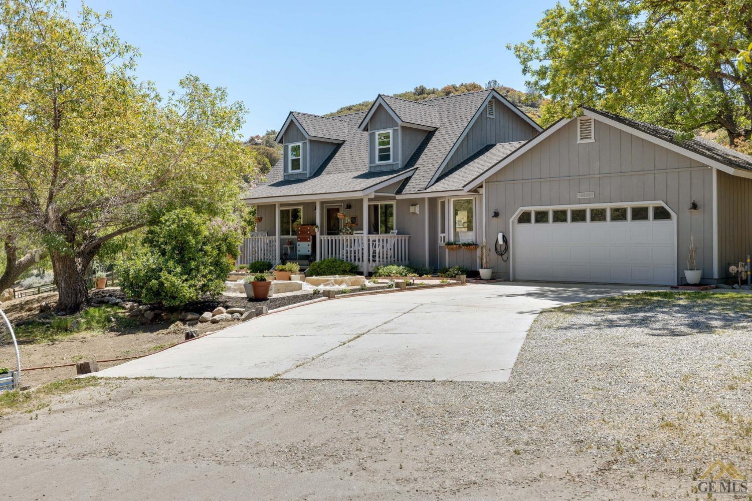 Undisclosed Address Tehachapi, CA 93561 - Photo 6 of 57 a view of a white house with a yard and large trees