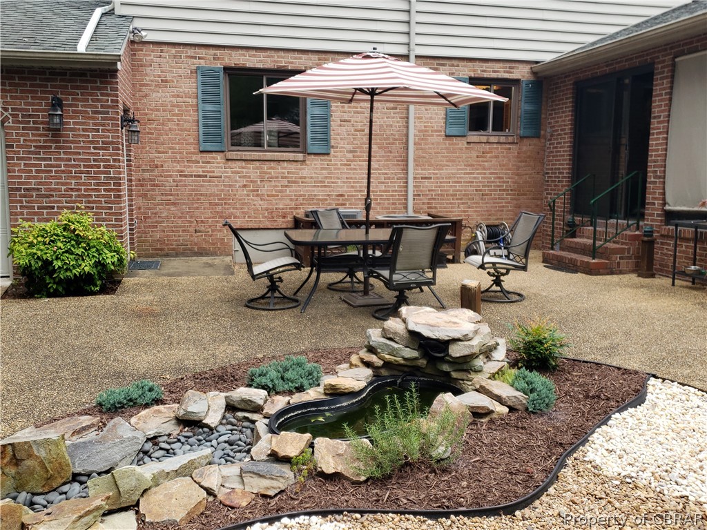 230 Treva Road Sandston, VA 23150 - Photo 9 of 40 Aggregate patio with water feature for relaxing outdoor dinner parties