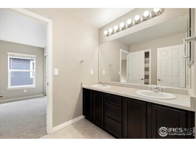 a bathroom with a sink vanity and mirror