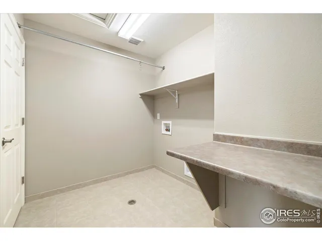 a utility room with a wooden floor
