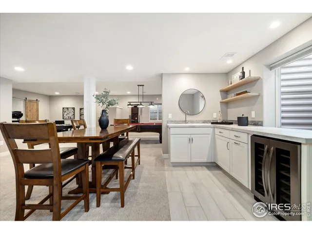 a kitchen with a table chairs sink and cabinets