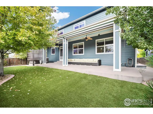 a backyard of a house with table and chairs